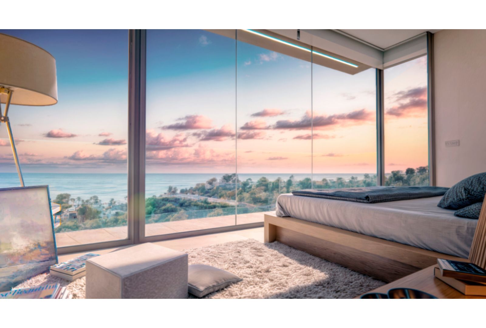 Slaapkamer met uitzicht op de oceaan bij zonsondergang.